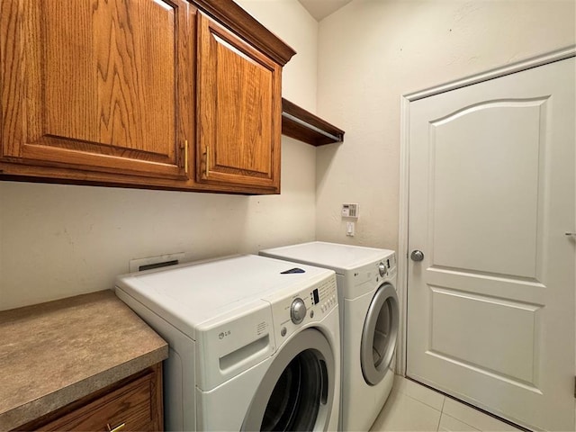 4409 Whitmere Ct, Norman, OK 73072 - laundry room with cabinet space, washer and clothes dryer, and light tile patterned floors