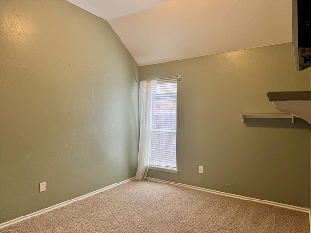 4409 Whitmere Ct, Norman, OK 73072 - carpeted empty room with vaulted ceiling and baseboards