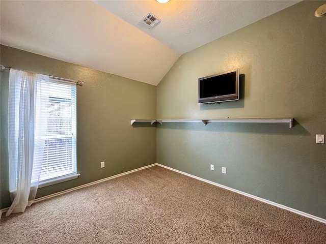 4409 Whitmere Ct, Norman, OK 73072 - carpeted empty room with lofted ceiling and baseboards
