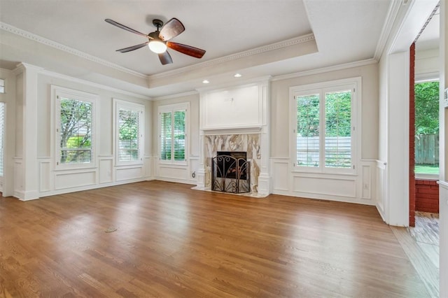 4609 Summerfield Ct, Norman, OK 73072 - unfurnished living room with a decorative wall, a tray ceiling, a fireplace, ornamental molding, and ceiling fan
