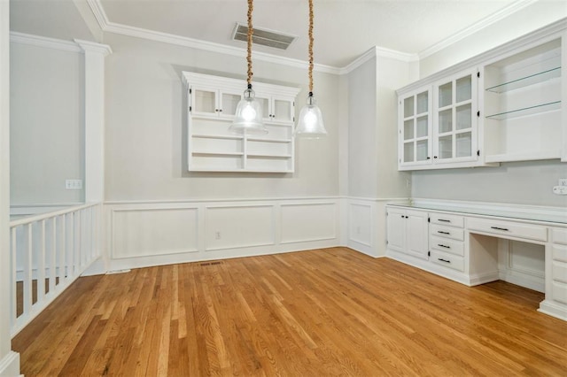 4609 Summerfield Ct, Norman, OK 73072 - unfurnished dining area with light wood-type flooring, ornamental molding, a wainscoted wall, and a decorative wall