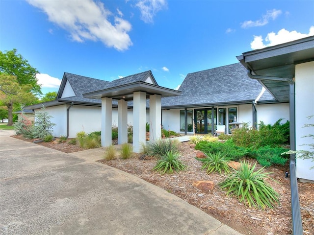 4107 Northhampton Dr, Norman, OK 73072 - view of front of house featuring stucco siding and roof with shingles