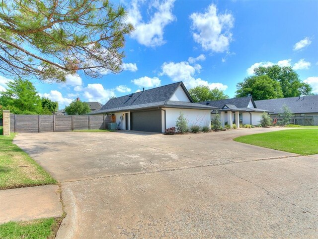 4107 Northhampton Dr, Norman, OK 73072 - view of front of property featuring an attached garage, concrete driveway, and stucco siding