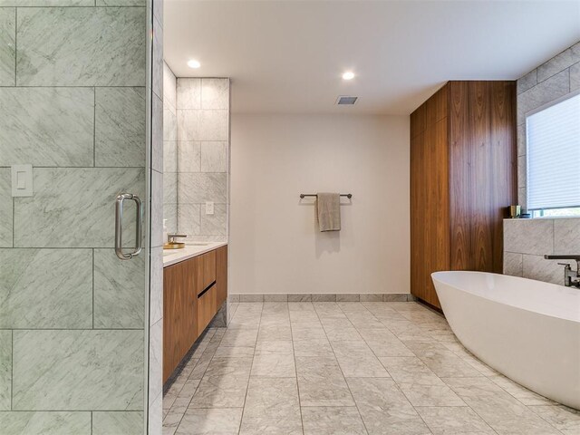 4107 Northhampton Dr, Norman, OK 73072 - bathroom with a soaking tub, vanity, a stall shower, and recessed lighting