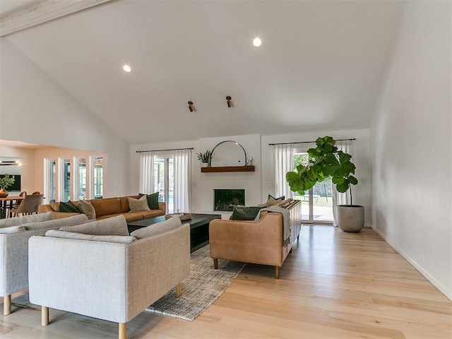 4107 Northhampton Dr, Norman, OK 73072 - living room with high vaulted ceiling, healthy amount of natural light, a fireplace, light wood finished floors, and recessed lighting