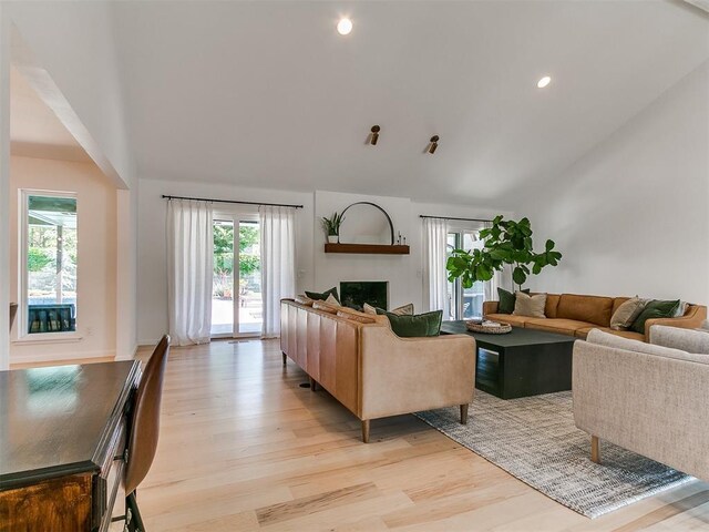 4107 Northhampton Dr, Norman, OK 73072 - living area with vaulted ceiling, light wood-style floors, plenty of natural light, a fireplace, and recessed lighting