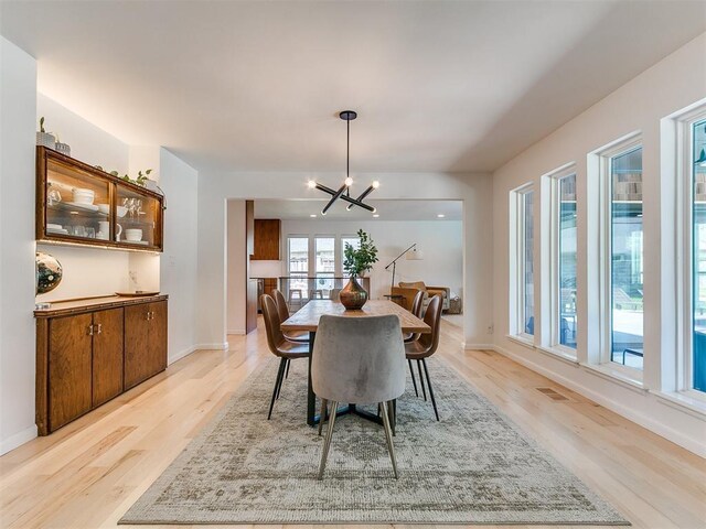 4107 Northhampton Dr, Norman, OK 73072 - dining space with a chandelier and light wood-style floors