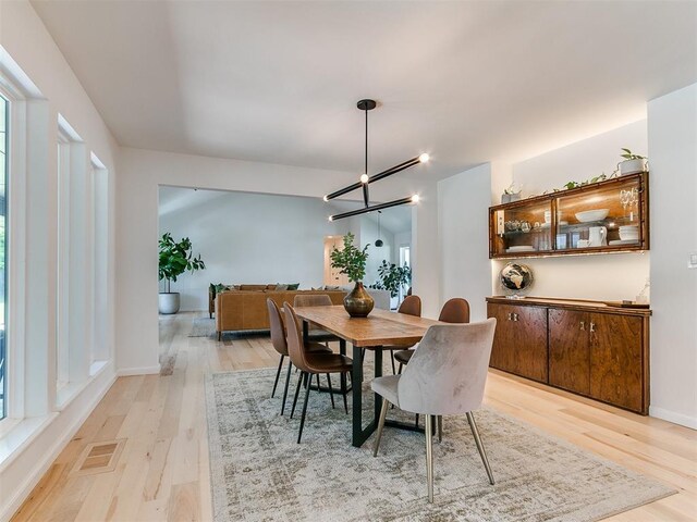 4107 Northhampton Dr, Norman, OK 73072 - dining area with light wood-style flooring and a chandelier