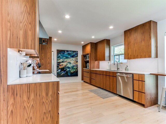 4107 Northhampton Dr, Norman, OK 73072 - kitchen featuring stainless steel dishwasher, brown cabinetry, light wood finished floors, light countertops, and recessed lighting