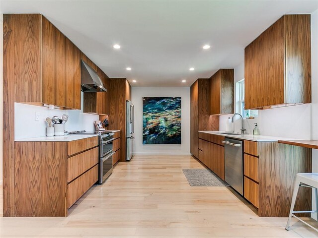 4107 Northhampton Dr, Norman, OK 73072 - kitchen featuring appliances with stainless steel finishes, ventilation hood, modern cabinets, recessed lighting, and light countertops