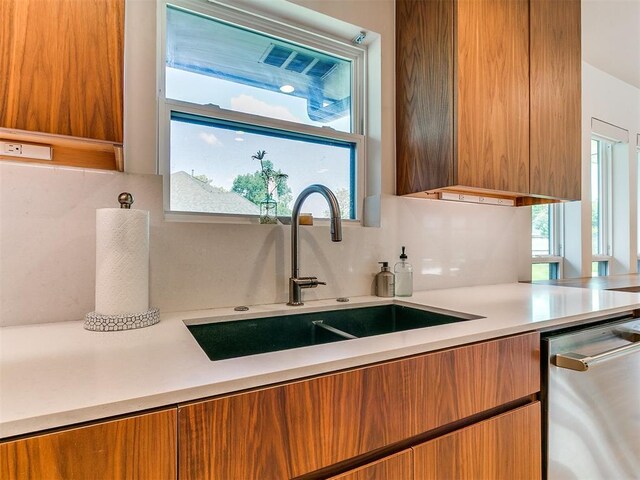 4107 Northhampton Dr, Norman, OK 73072 - kitchen featuring brown cabinets, stainless steel dishwasher, and light countertops