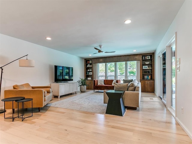4107 Northhampton Dr, Norman, OK 73072 - living area with light wood finished floors, ceiling fan, built in features, and recessed lighting