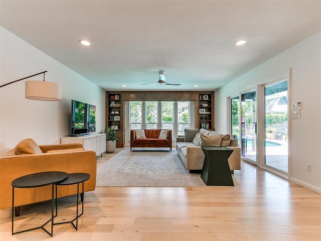 4107 Northhampton Dr, Norman, OK 73072 - living area featuring built in shelves, light wood-style flooring, recessed lighting, and a ceiling fan