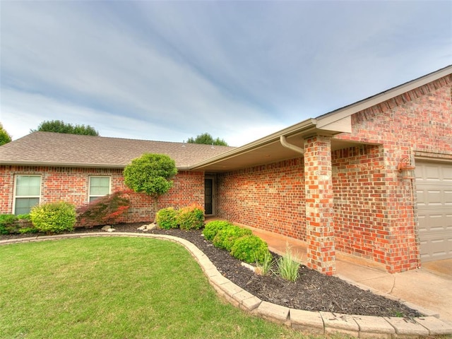 7204 Walnut Creek Dr, Oklahoma City, OK 73142 - doorway to property with brick siding, a garage, a yard, and roof with shingles