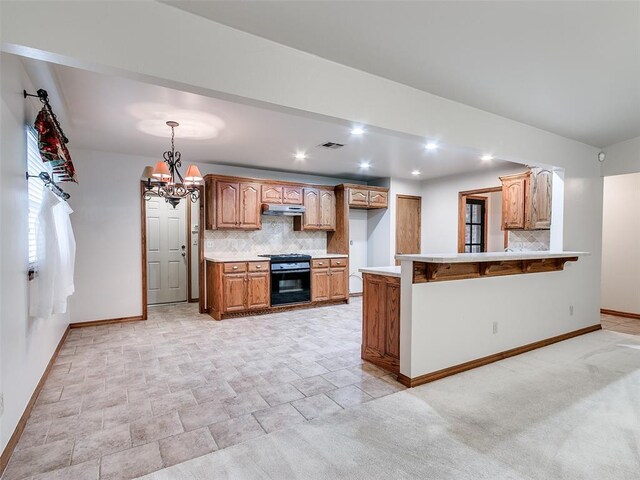 7204 Walnut Creek Dr, Oklahoma City, OK 73142 - kitchen featuring range hood, decorative backsplash, light countertops, a peninsula, and black stove