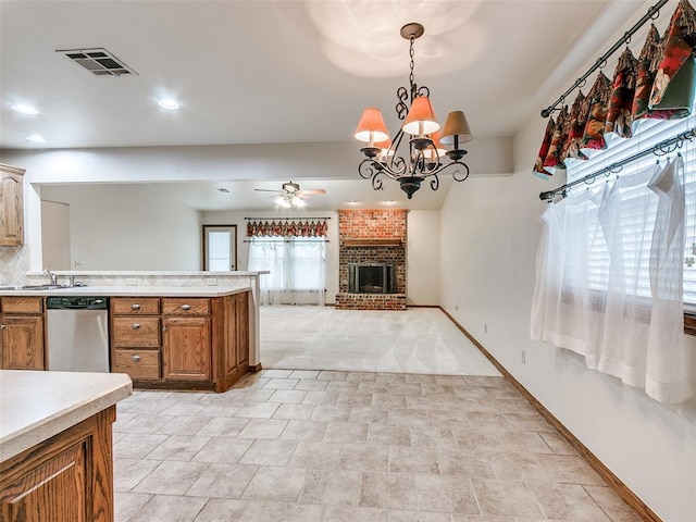 7204 Walnut Creek Dr, Oklahoma City, OK 73142 - kitchen featuring dishwasher, light countertops, ceiling fan, brown cabinetry, and a brick fireplace