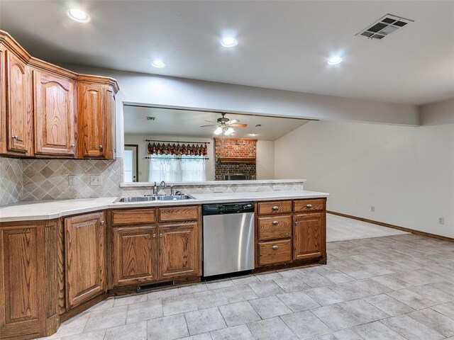 7204 Walnut Creek Dr, Oklahoma City, OK 73142 - kitchen featuring stainless steel dishwasher, ceiling fan, tasteful backsplash, light countertops, and brown cabinetry