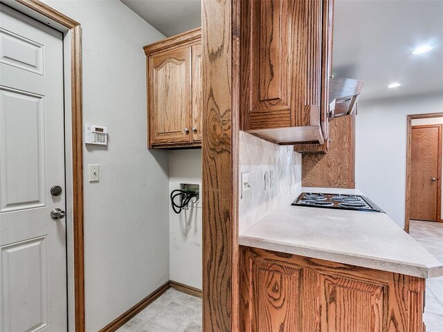 7204 Walnut Creek Dr, Oklahoma City, OK 73142 - kitchen with black electric cooktop, decorative backsplash, light countertops, range hood, and recessed lighting