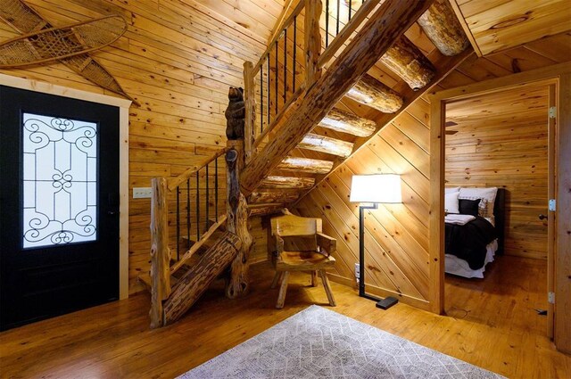 185 Marlin Dr, Broken Bow, OK 74728 - foyer entrance featuring wood walls, wooden ceiling, wood-type flooring, and stairs