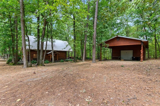 185 Marlin Dr, Broken Bow, OK 74728 - view of yard with a garage, an outdoor structure, and dirt driveway