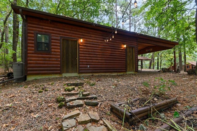 185 Marlin Dr, Broken Bow, OK 74728 - back of property featuring log veneer siding and a garden