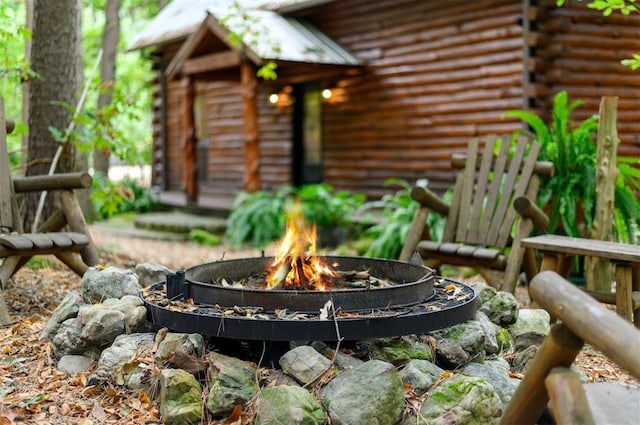 185 Marlin Dr, Broken Bow, OK 74728 - exterior view of log exterior and a fire pit