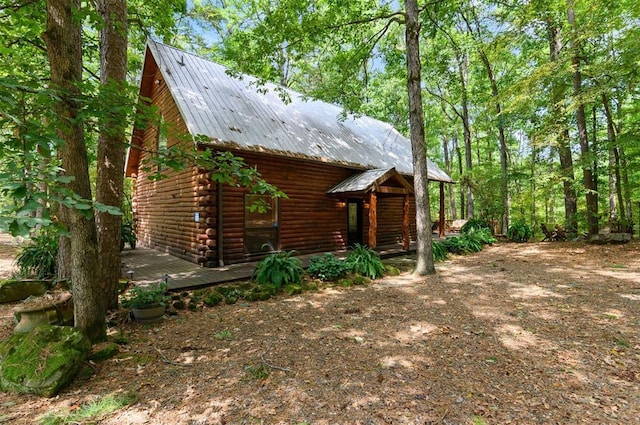 185 Marlin Dr, Broken Bow, OK 74728 - view of front of home with metal roof and log siding