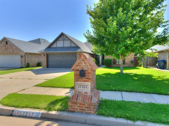 17217 Prado Dr, Oklahoma City, OK 73170 - tudor home with brick siding, driveway, and a garage