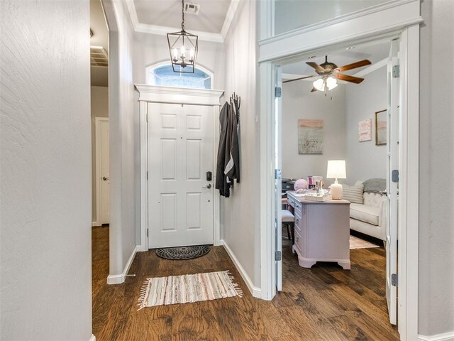 17217 Prado Dr, Oklahoma City, OK 73170 - entryway featuring crown molding, wood finished floors, ceiling fan, baseboards, and a chandelier