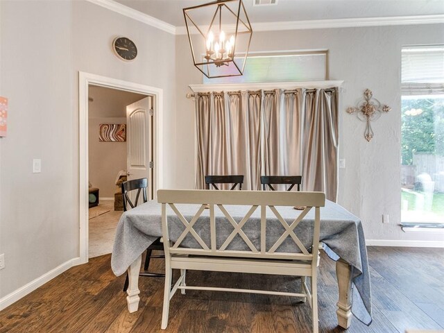 17217 Prado Dr, Oklahoma City, OK 73170 - dining area with a chandelier, ornamental molding, baseboards, and dark wood-style flooring