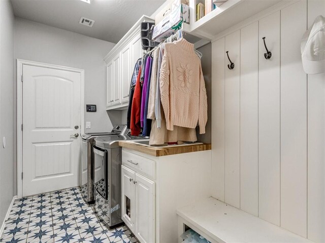 17217 Prado Dr, Oklahoma City, OK 73170 - laundry room featuring light floors, washer and dryer, and cabinet space