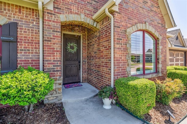 908 Carol Ann Pl, Moore, OK 73160 - view of exterior entry featuring brick siding and an attached garage