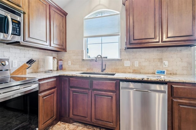 908 Carol Ann Pl, Moore, OK 73160 - kitchen featuring stainless steel appliances, tasteful backsplash, and light stone countertops
