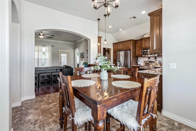 908 Carol Ann Pl, Moore, OK 73160 - dining area with arched walkways, lofted ceiling, a ceiling fan, and a chandelier