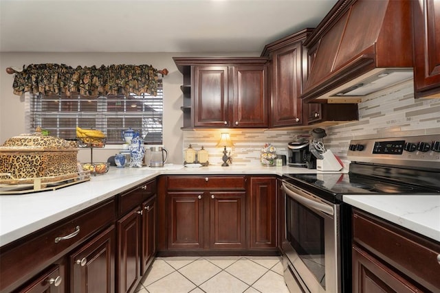 5108 NW 19th Ter, Oklahoma City, OK 73127 - kitchen featuring electric range, premium range hood, decorative backsplash, and light tile patterned floors