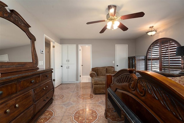 5108 NW 19th Ter, Oklahoma City, OK 73127 - bedroom with light tile patterned floors and ceiling fan