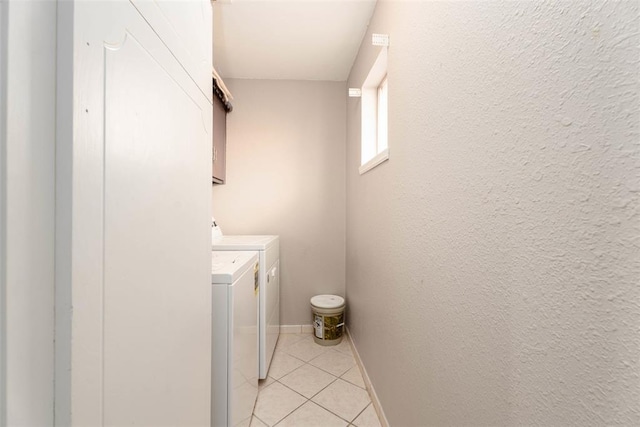 5108 NW 19th Ter, Oklahoma City, OK 73127 - washroom with washing machine and dryer, light tile patterned floors, and baseboards