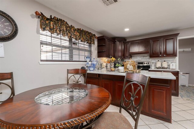 5108 NW 19th Ter, Oklahoma City, OK 73127 - kitchen featuring a peninsula, light countertops, backsplash, and light tile patterned floors