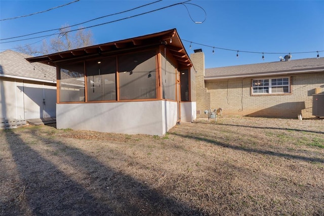 5108 NW 19th Ter, Oklahoma City, OK 73127 - back of house with a sunroom, a chimney, and brick siding