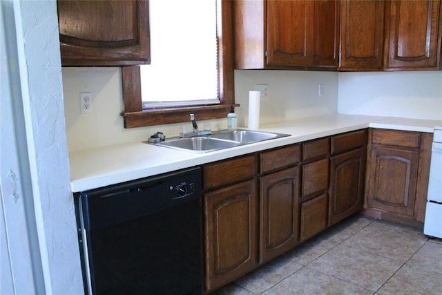 1521 SW 45th St, Oklahoma City, OK 73119 - kitchen with black dishwasher, a sink, light countertops, and light tile patterned flooring