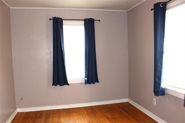 1521 SW 45th St, Oklahoma City, OK 73119 - unfurnished room with healthy amount of natural light, hardwood / wood-style flooring, baseboards, and crown molding