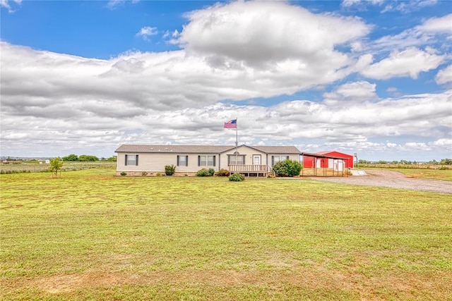 20649 E 1110th Rd, Canute, OK 73626 - manufactured / mobile home featuring a wooden deck, a front lawn, and an outdoor structure