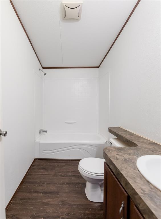 20649 E 1110th Rd, Canute, OK 73626 - bathroom with vanity, wood finished floors, tub / shower combination, and toilet