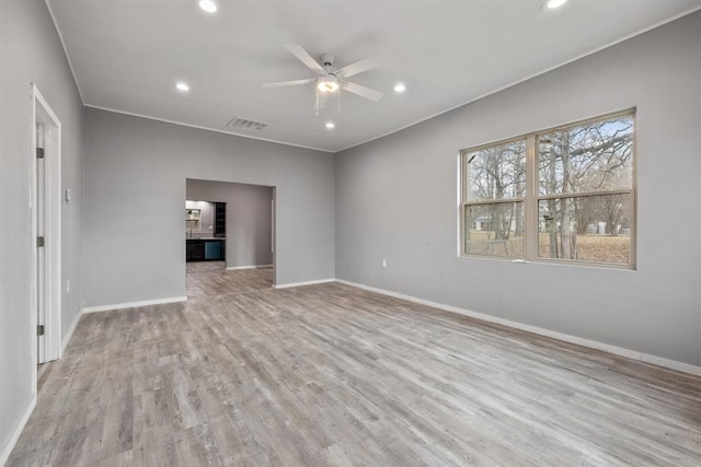 305 E Laurel St, Hugo, OK 74743 - spare room with a ceiling fan, baseboards, light wood finished floors, recessed lighting, and crown molding