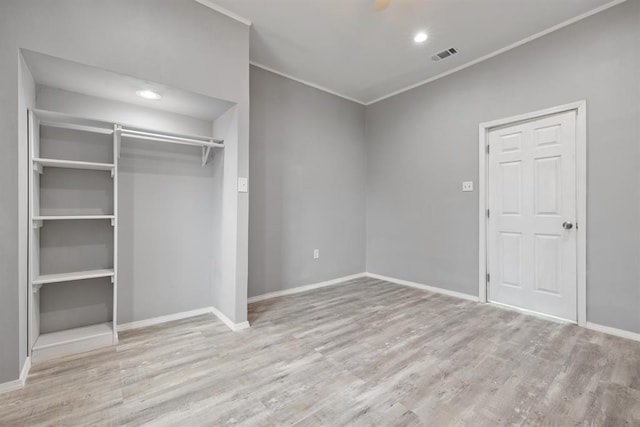 305 E Laurel St, Hugo, OK 74743 - unfurnished bedroom with ornamental molding, wood finished floors, a closet, baseboards, and recessed lighting
