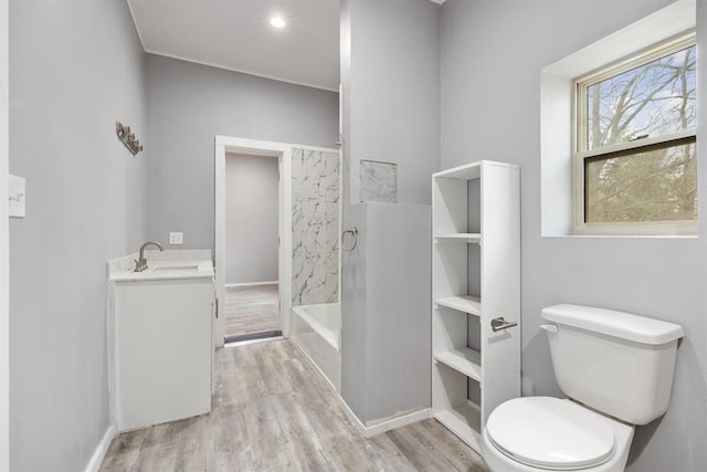 305 E Laurel St, Hugo, OK 74743 - bathroom featuring toilet, wood finished floors, vanity, and shower / bath combination
