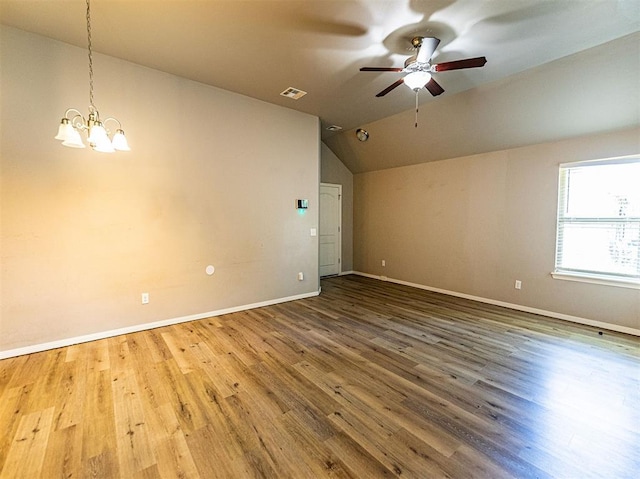 4212 Bonaparte Blvd, Midwest City, OK 73110 - spare room with lofted ceiling, ceiling fan, baseboards, wood finished floors, and a chandelier