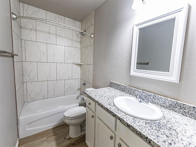 4212 Bonaparte Blvd, Midwest City, OK 73110 - full bathroom featuring vanity, wood finished floors, toilet, shower / bathtub combination, and a textured wall