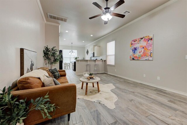 8340 NW 137th St, Oklahoma City, OK 73142 - living room with crown molding, a ceiling fan, light wood-type flooring, and recessed lighting