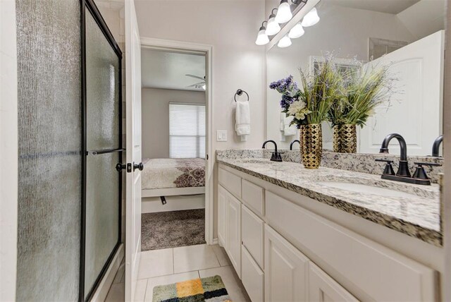 8340 NW 137th St, Oklahoma City, OK 73142 - bathroom featuring double vanity, a stall shower, tile patterned flooring, and connected bathroom